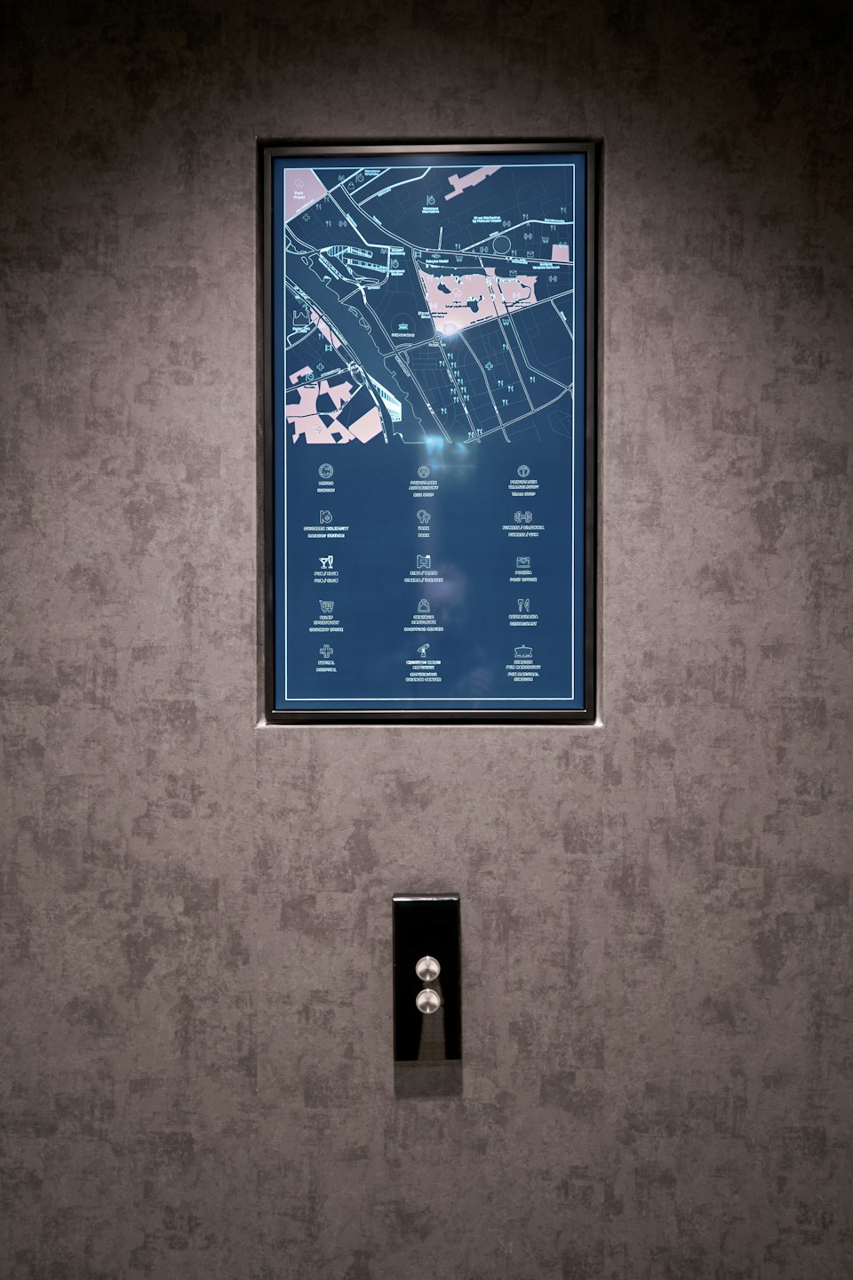 Digital directory map mounted on a dark textured wall.